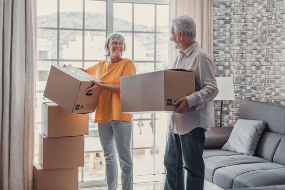 A couple moving boxes together