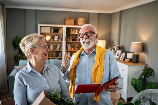 Couple laughing while going through belongings