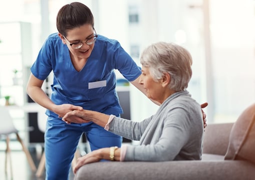 A nurse helping a lady in her home